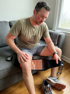 Person wearing the Glouren red light therapy belt at home during a recovery session